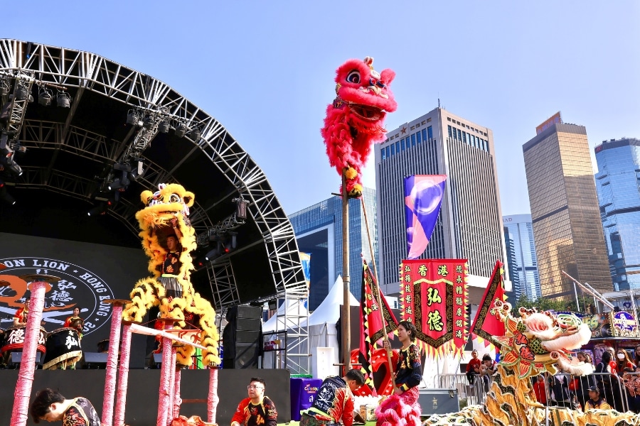 two lions are performing lion dance at aia carnival in central harbourfront