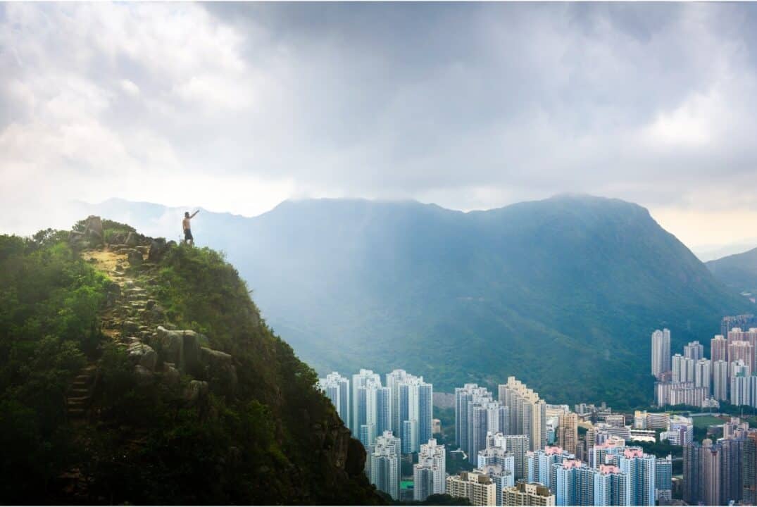 A man stands on Lion's Rock in Hong Kong and surveys the township of Sha Tin.