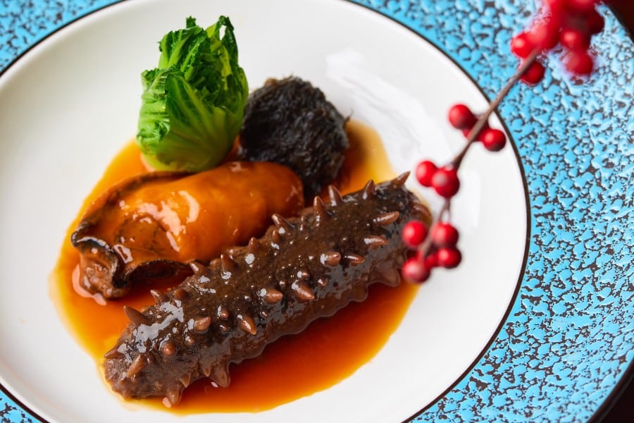 the Braised sea cucumber with sun-dried oyster and black moss dish from the legacy house of rosewood hong kong hotel