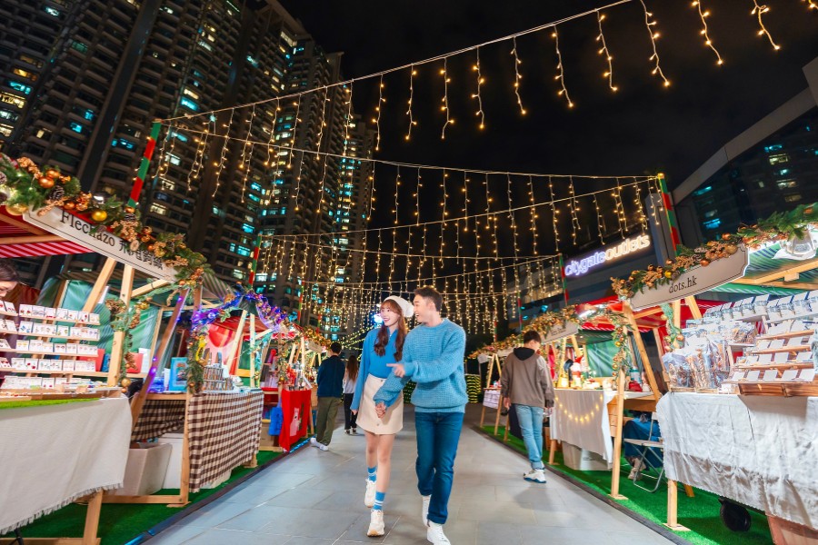couple walking at citygate outlets' outdoor christmas market
