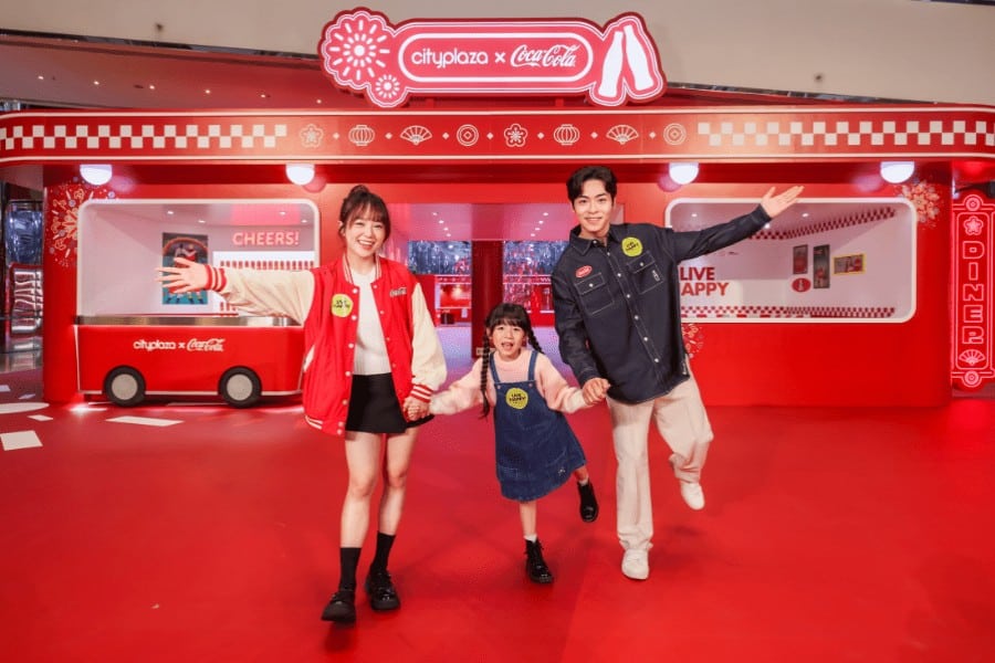 family posing at cityplaza cny installation in collab with coca cola