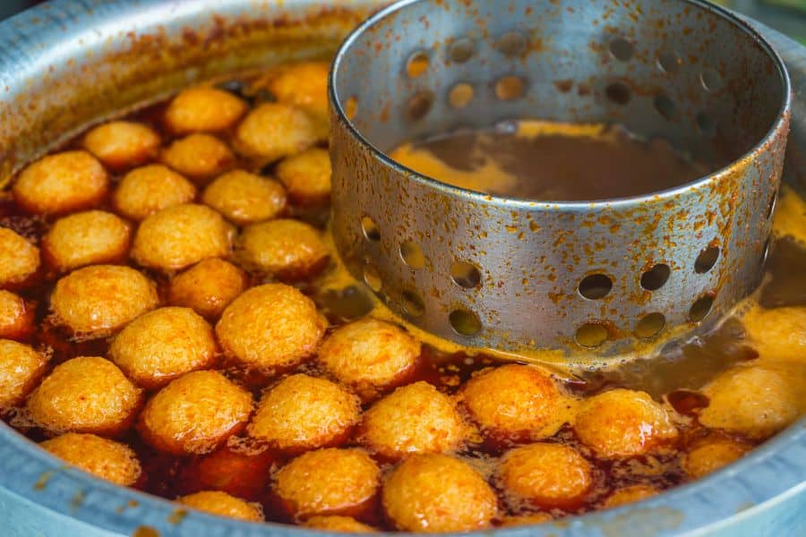 curry fish balls simmering in a rice cooker