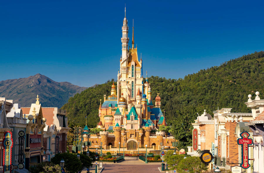hong kong disneyland castle mountains in background