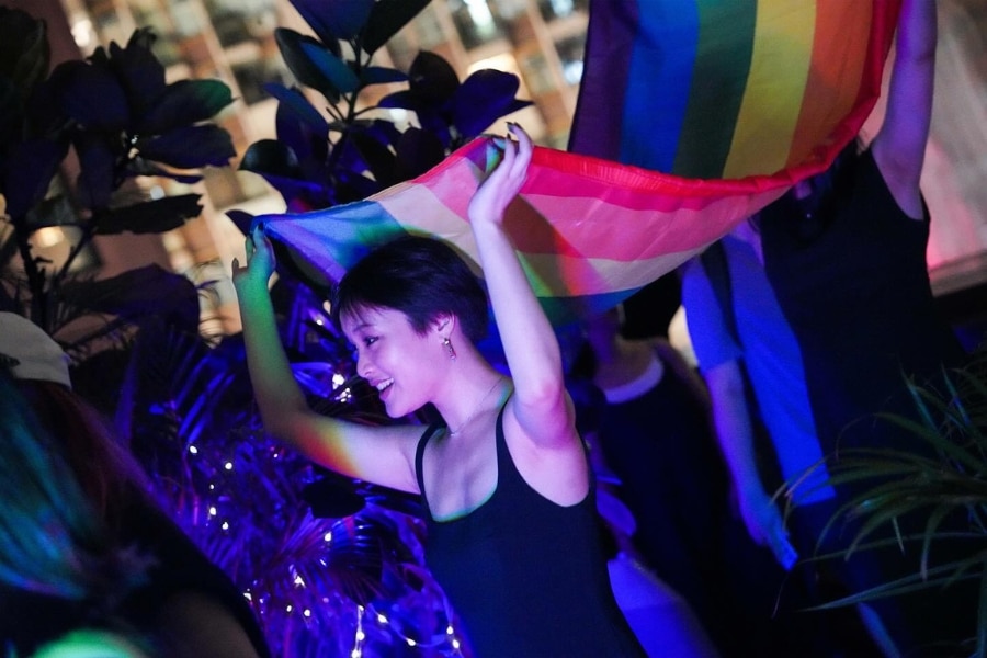 a lady carrying pride flag at eaton hotel