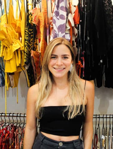 vipop cofounder fabiana gonzalez standing with sustainable swimwear and resortwear in hong kong store