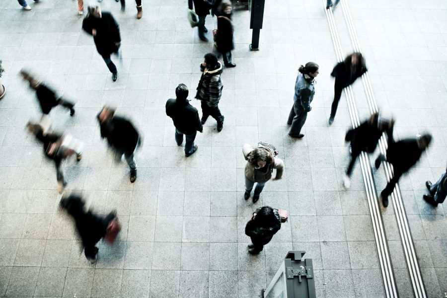 blurry individuals walking in crowd