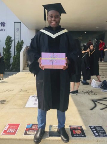 innocent mutanga wearing graduation robe