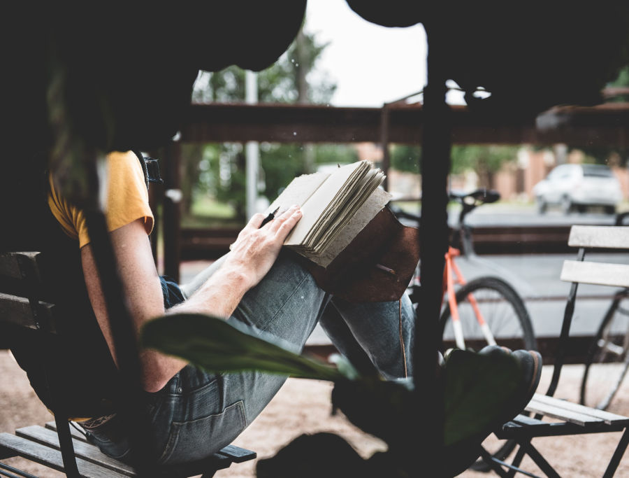 person journalling outside