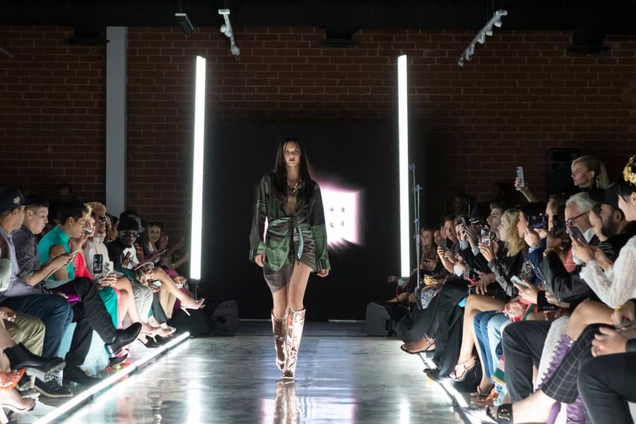 model walking down runway at lumiere runway fashion show