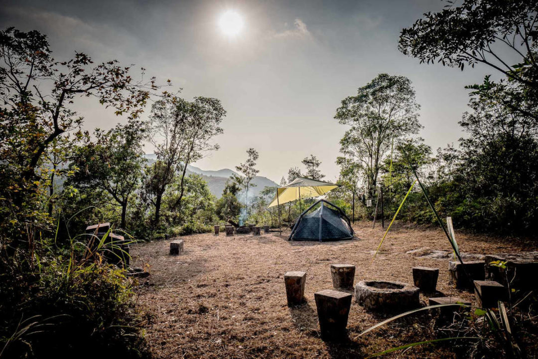 barbecue pit and tent at man cheung po campsite lantau island