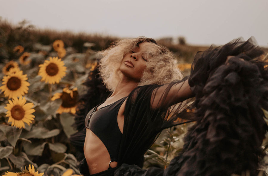 woman dancing in a sunflower field