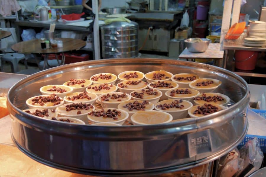 a pan of many steamed red bean puddings