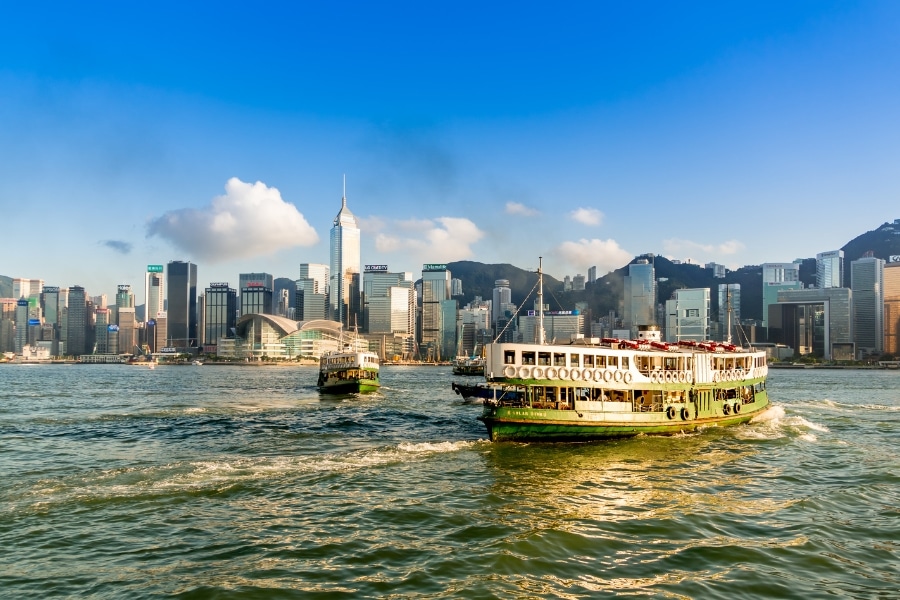 star ferry going across victoria harbour during sunset