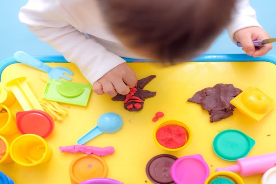 a kid playing with clay