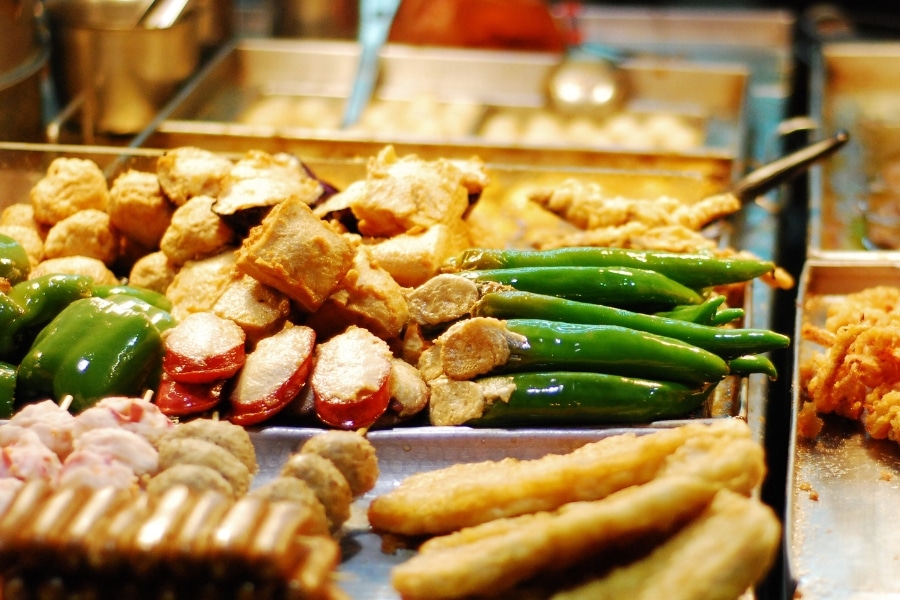 three fried stuffed treasures displayed at a street food stall in hong kong